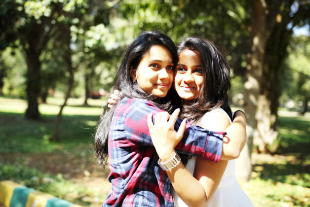 istock Two Girls Hugging in the Park 695171432