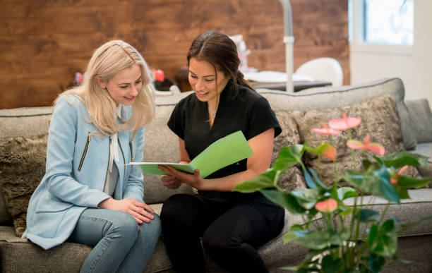 Woman working at a spa talking to a customer