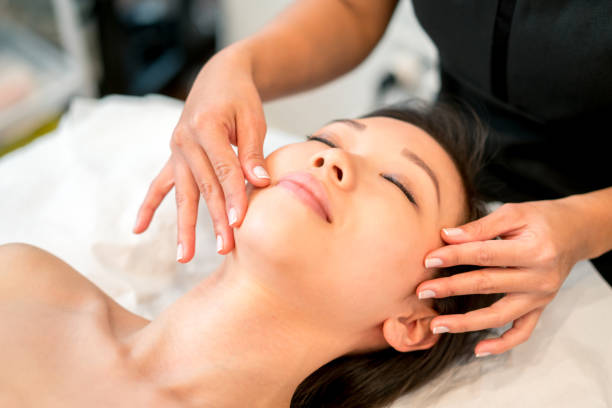 istock Asian woman getting a face massage at the spa 695177322