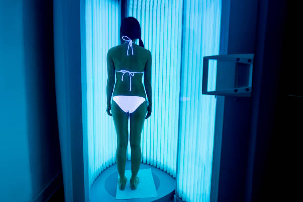 istock Woman getting tan in a solarium at the spa 695177364