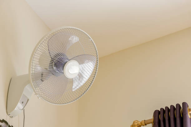 wall fan in the bedroom stock photo