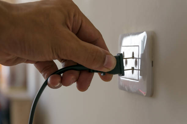 electrical plug socket on the wall - electric plug outlet human hand electricity imagens e fotografias de stock