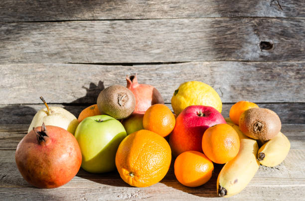 istock Fruits on wooden background 695183874