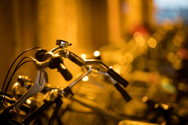 Black classic bike by the canal at night in Amsterdam.