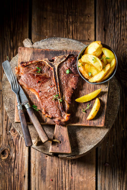 istock Delicious tbone steak and chips on old barrel 695186554