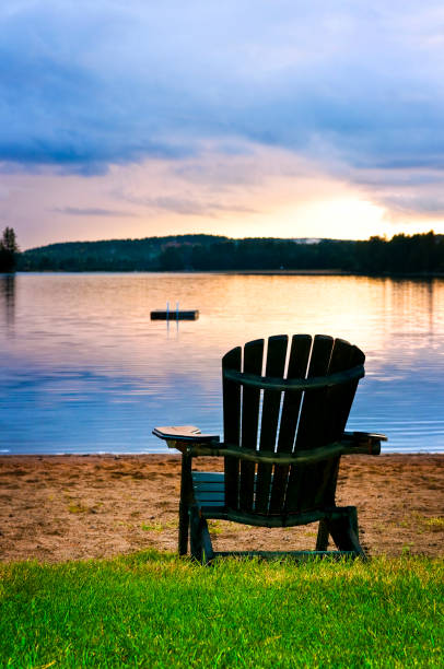 istock Wooden chair at sunset on beach 695189210