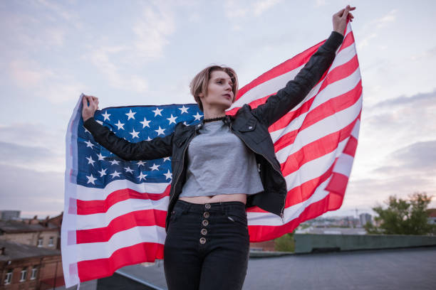 istock Girl with USA flag behind the back 695211978