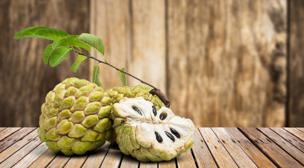 custard apple on wooden table Ripe of custard apple on the wooden table annonaceae stock pictures, royalty-free photos & images