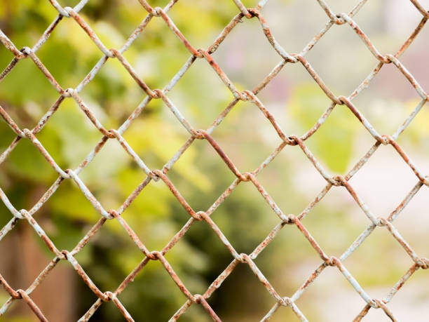 istock Rusty colored mesh netting. The metal fence 695216236