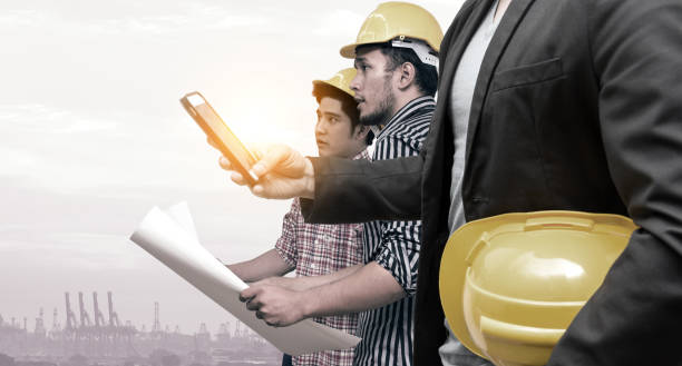 istock Smart construction in industry 4.0 concept. Double exposure of Business hand suit using mobile phone and two engineers with flare light effect. 695221544