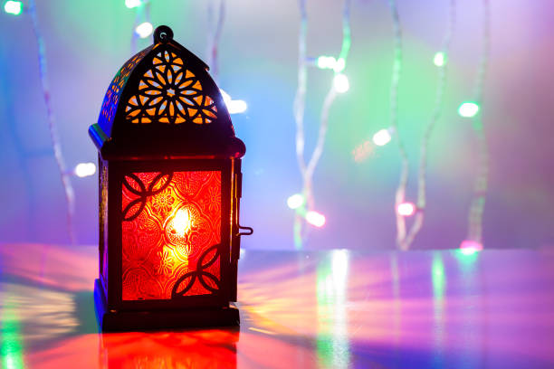 istock Arabic Lantern illuminated in colorful background 695224258