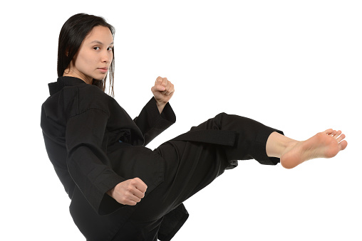 Martial artist kicking from a fighting stance.