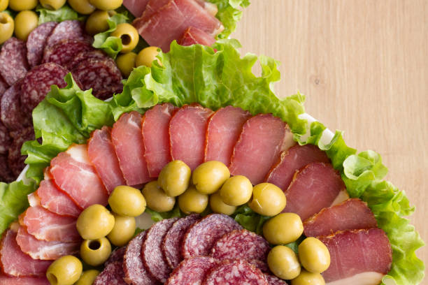 Sliced Sausage and Meat on a Plate. Copy Space