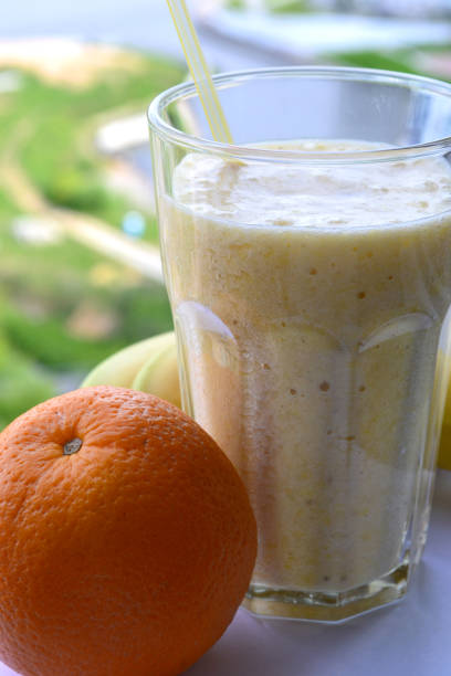 istock A composition of bananas and orange and a glass with smoothies 695230656