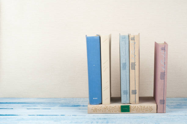 istock Book stacking, hardback books on wooden table. Back to school. Copy space for text 695249076