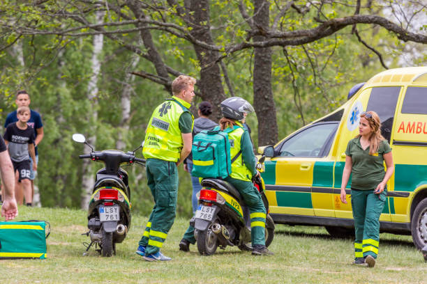 Ambulance vehicles and personnel outdoors. stock photo