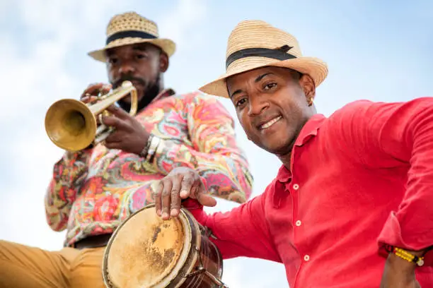 Professional Cuban conga drum player against blue sky, low angle viewCuban musician with trumpet against blue sky, Havana, Cuba