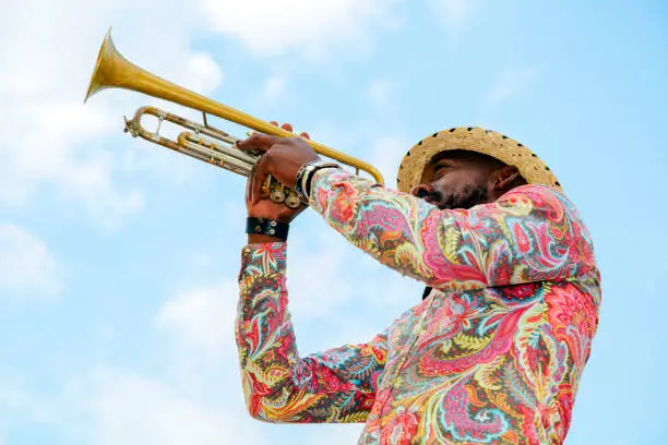 Cuban musician with trumpet against blue sky, Havana, Cuba