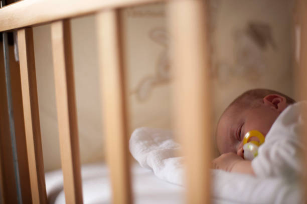 istock Newborn baby sleeping with nipple 695260458