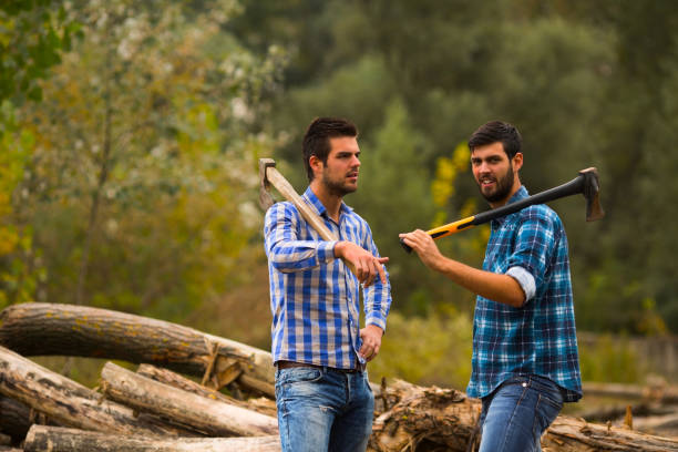 istock Two guys talking in the forest after logging with axes on their shoulders 695260676
