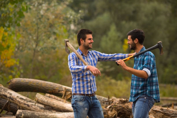 istock Two guys talking in the forest after logging with axes on their shoulders 695261024