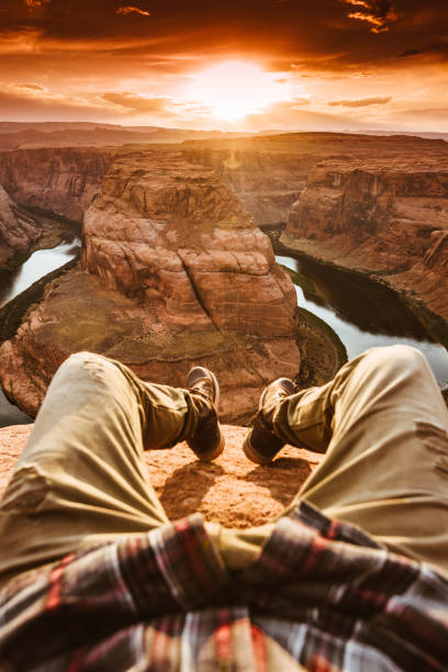 istock man living on the edge at the horseshoe bend 695263680