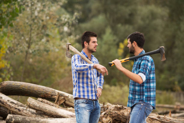 istock Two guys talking in the forest after logging with axes on their shoulders 695263984