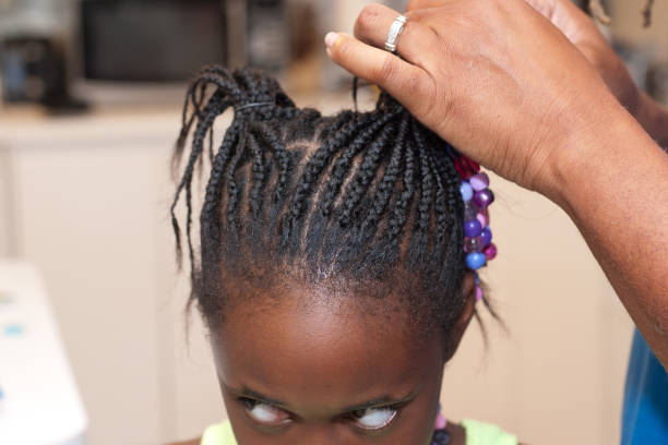 istock A Black father doing his daughter's hair 695264656