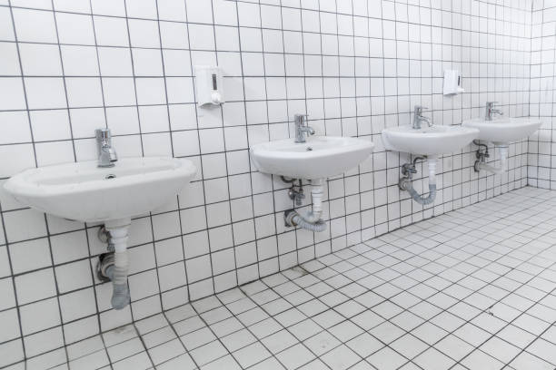 Four washbasin in a row inside public toilet