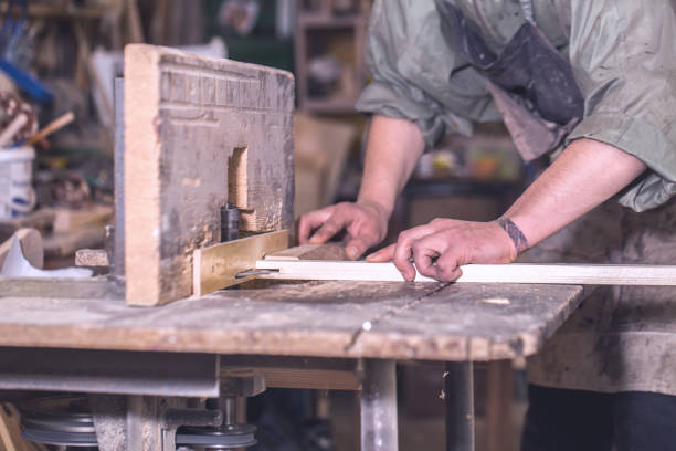 istock a man working with wood product on the machine 695264750