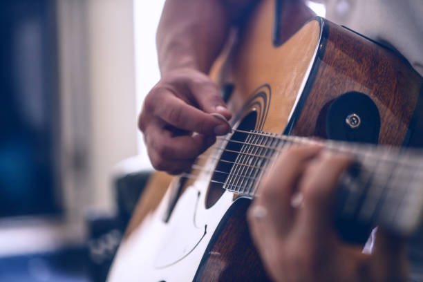 istock the guy playing the acoustic guitar 695264782