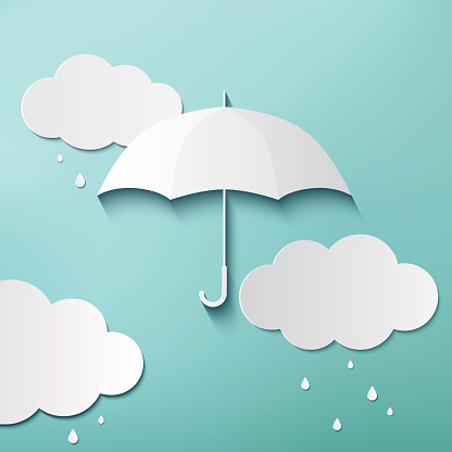 Rainy day, origami made umbrella and clouds on blue sky background