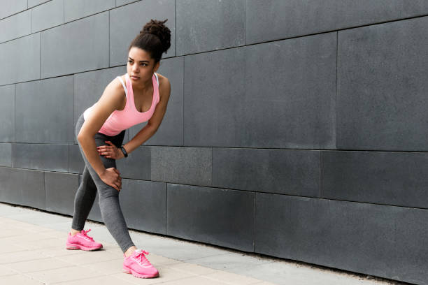istock Young woman warming up for training outdoors 695269806