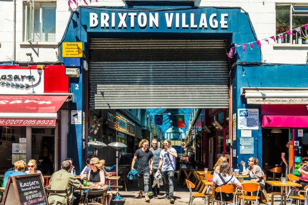 Brixton Village sign London: Brixton Market - Colorful and multicultural community market run by local traders in South London. Brixton Village sign brixton stock pictures, royalty-free photos & images