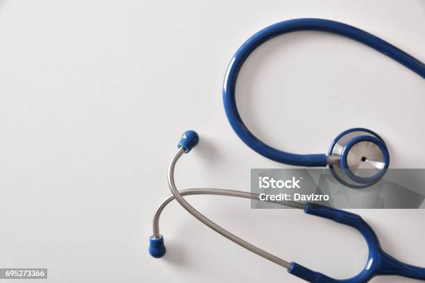 Blue Stethoscope On White Table Stock Photo - Download Image Now - Analyzing, Blue, Cardiologist