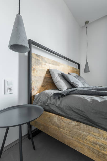 istock Ascetic bedroom with wooden bed 695275956