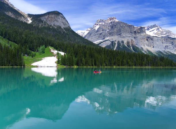 istock Bright Red Canoe Floating on Turquoise Canadian Lake 695276382