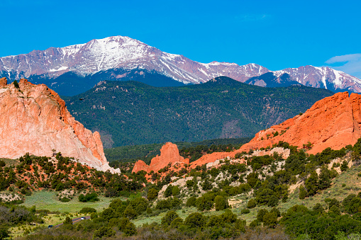 Garden of the Gods in early summer with snow capped Pikes Peak in the background.