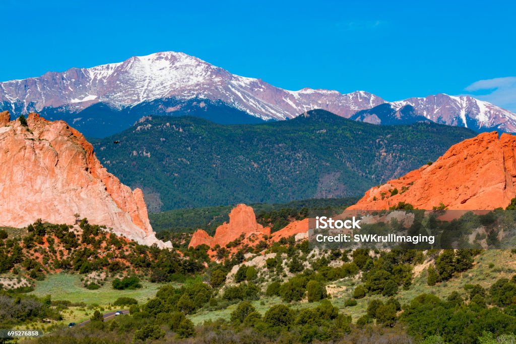 Summer Garden of the Gods Garden of the Gods in early summer with snow capped Pikes Peak in the background. Pikes Peak Summit - Colorado Stock Photo