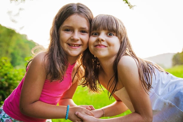 istock Two happy girls outside 695282022