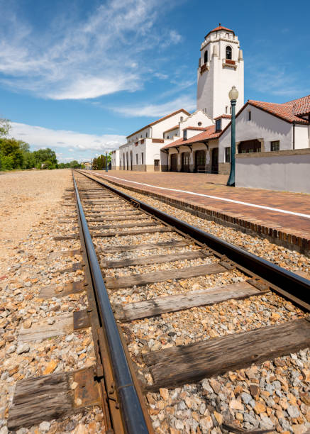 istock railroad tracks lead past a local train depot 695282032