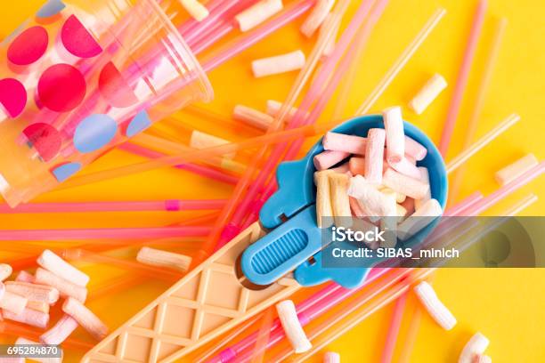 Multicolored Pastel Background Or Colorful Texture With Top View Pastel Tasty Fluffy Sweet Mini Marshmallows Minimal Summer Holiday Style Blue Icecream Spoon And Plastic Cocktail Ducts Stock Photo - Download Image Now