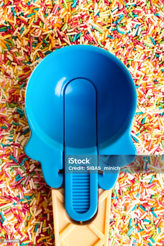 Multicolored Pastel background or colorful texture with top view. Pastel tasty fluffy sweet mini marshmallows. Minimal summer holiday style. Blue ice-cream Spoon and plastic cocktail ducts Apple - Fruit Stock Photo