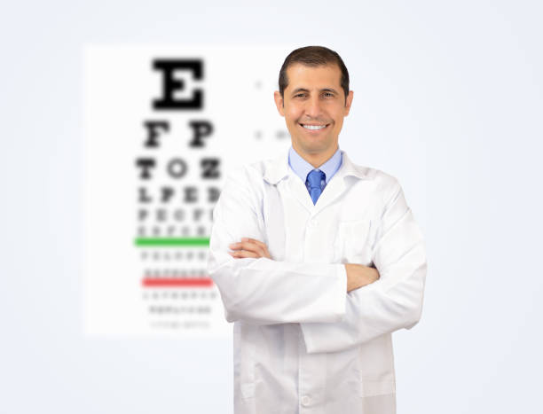 istock smiling male doctor with eye chart 695287966