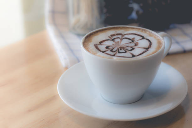 istock hot coffee with foam milk art in afternoon break. (selective focus, vintage effect) 695295050