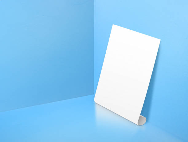 istock Blank white rolling poster at corner painted pastel blue color studio room background,Mock up template for display or montage of design or text ,Online marketing media tool 695299208