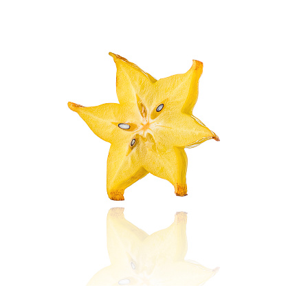 Half of Carambola, star fruit, slice, isolated on white background with drop shadow.