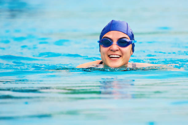 istock Smiling swimming woman 695308102
