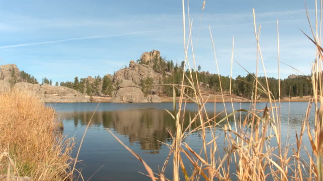 Scenic Sylvan Lake shoreline and rugged rocky outcrops covered with pine trees