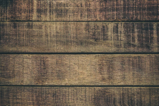 istock Vintage surface wood table and rustic grain texture background. Close up of dark rustic wall made of old wood table planks texture. Rustic brown wood table texture background template for your design. 695313390